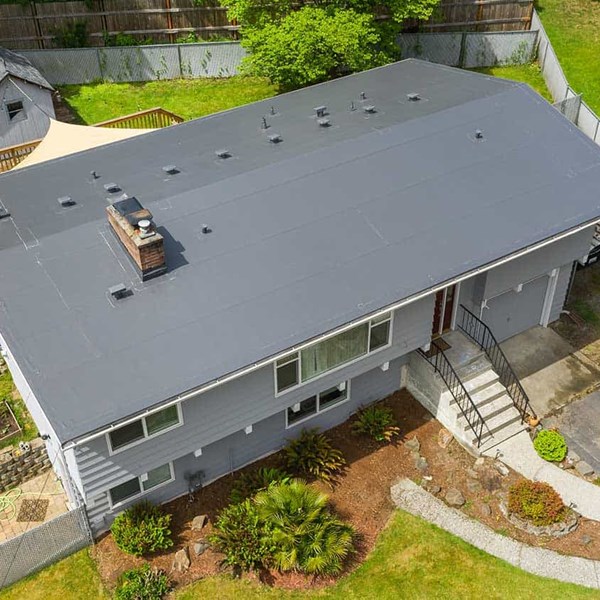 Ariel view of a home with a gray pvc roof.