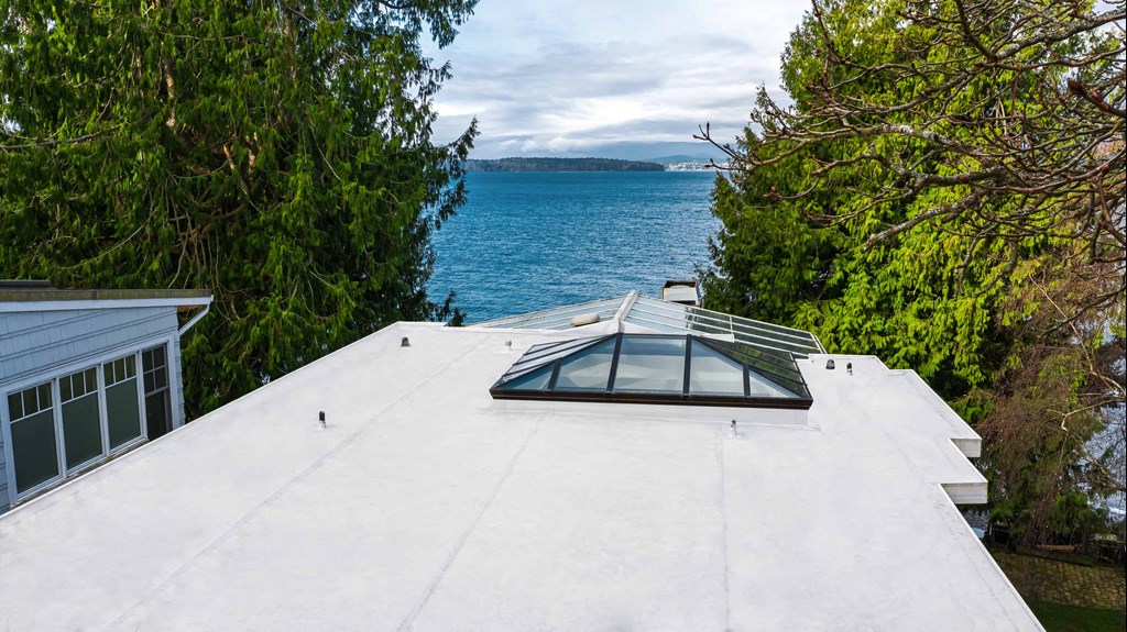 Top View of Modern Roof of House with Flat PVC Roofing with Roof Window - Seattle, WA - Valentine Roofing