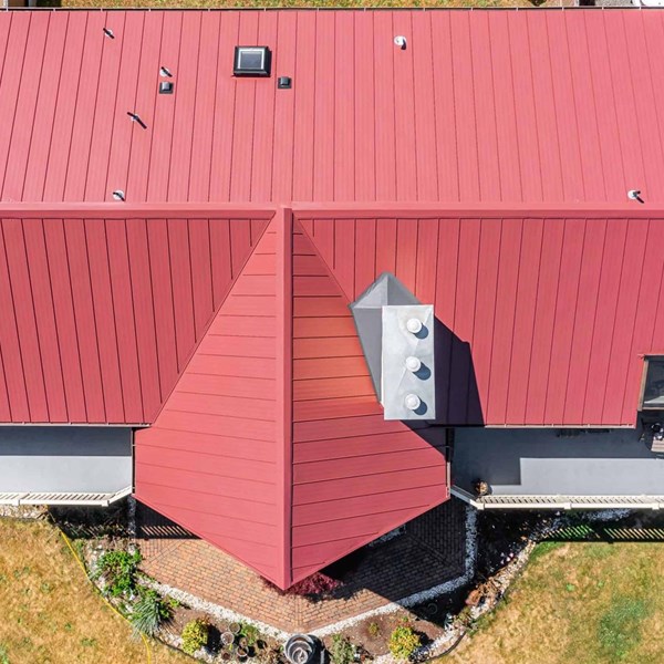 Roy Standing Seam Metal Panel in Colonial Red on two story home