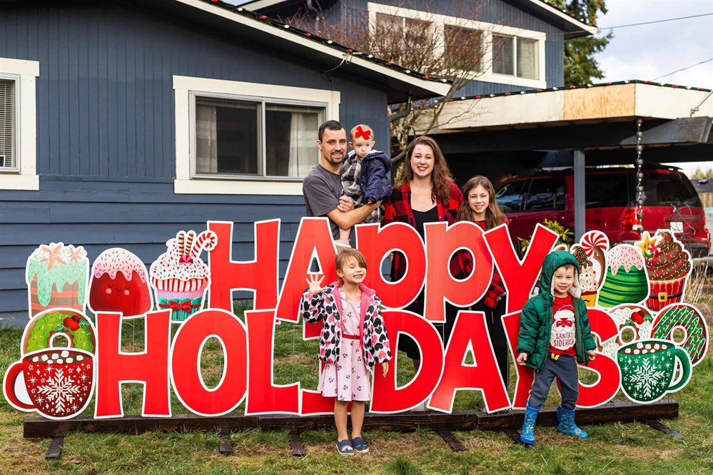 The Mnieriem Family Standing outside their home with a new roof